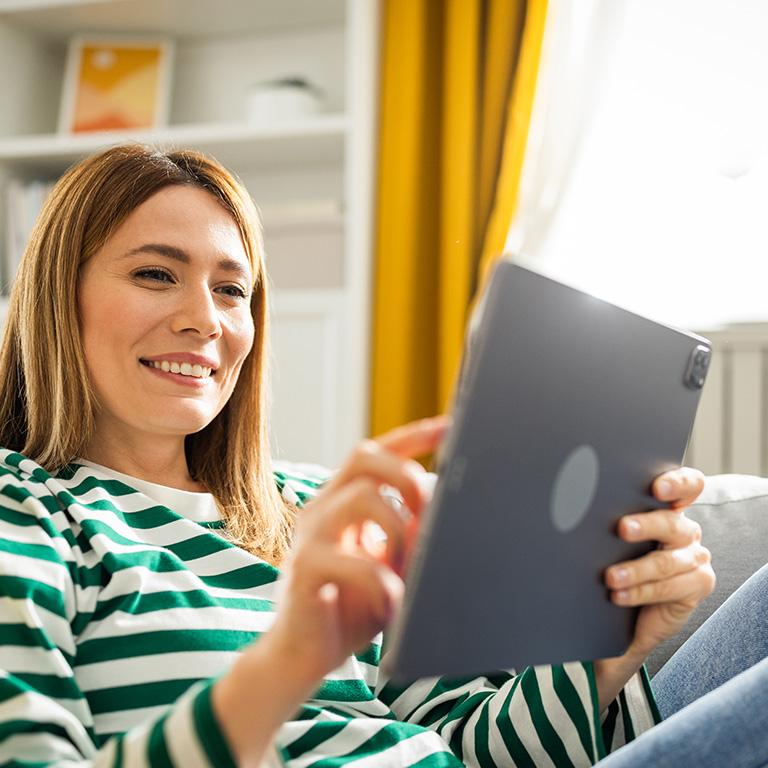 woman smiling at tablet