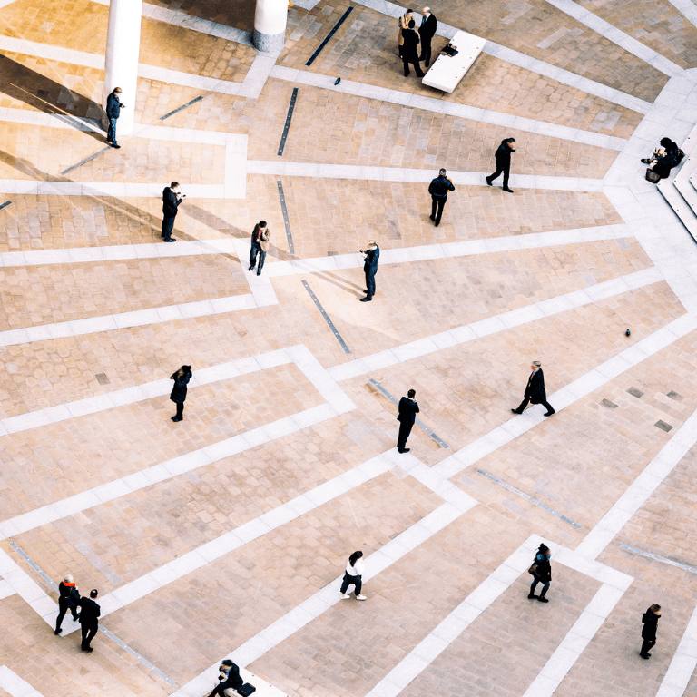 birds eye view of people walking in a city plaza