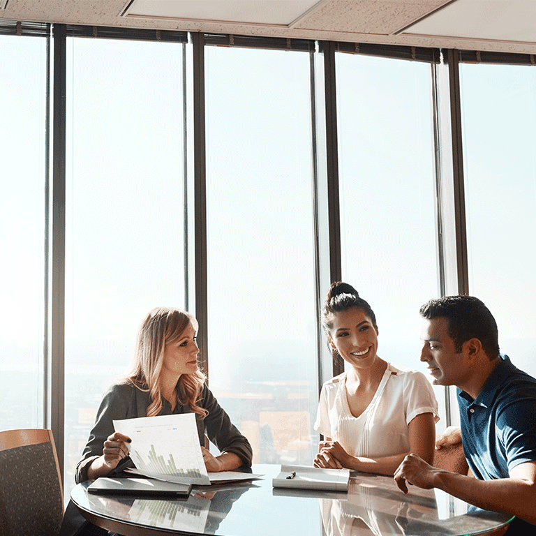 people at a table looking over a graph