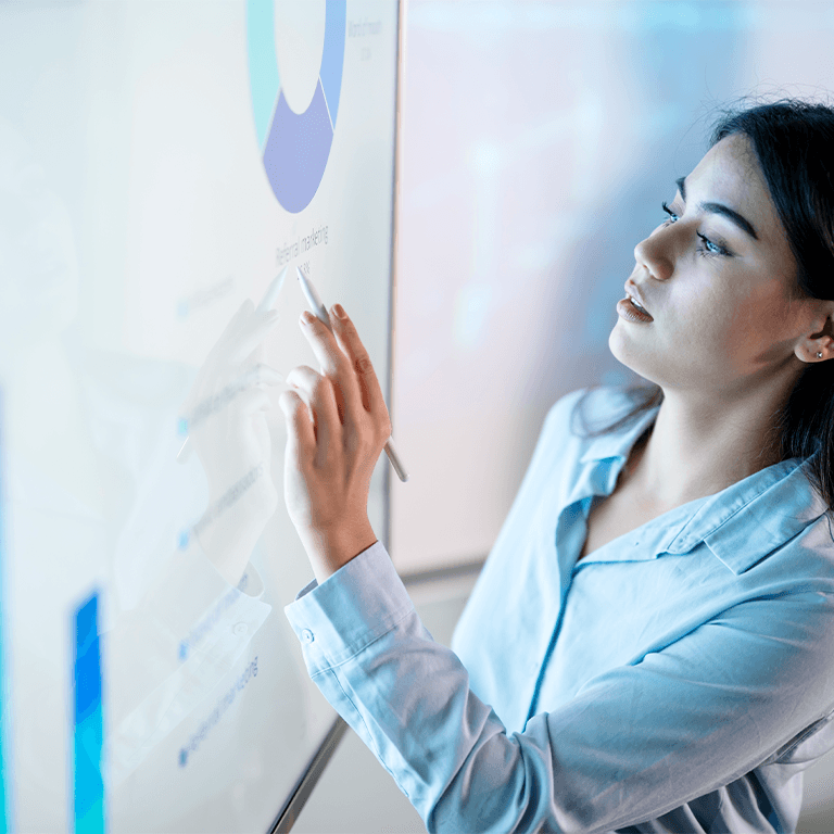 Woman writing on board
