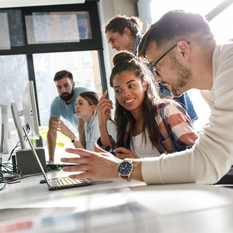 people working on a laptop together