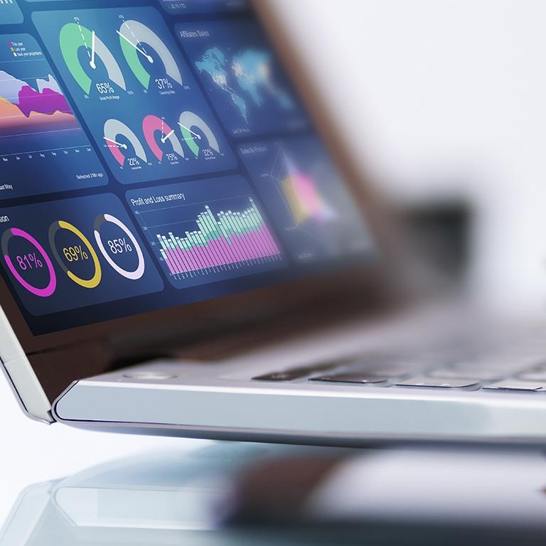 laptop with dashboard of charts on it