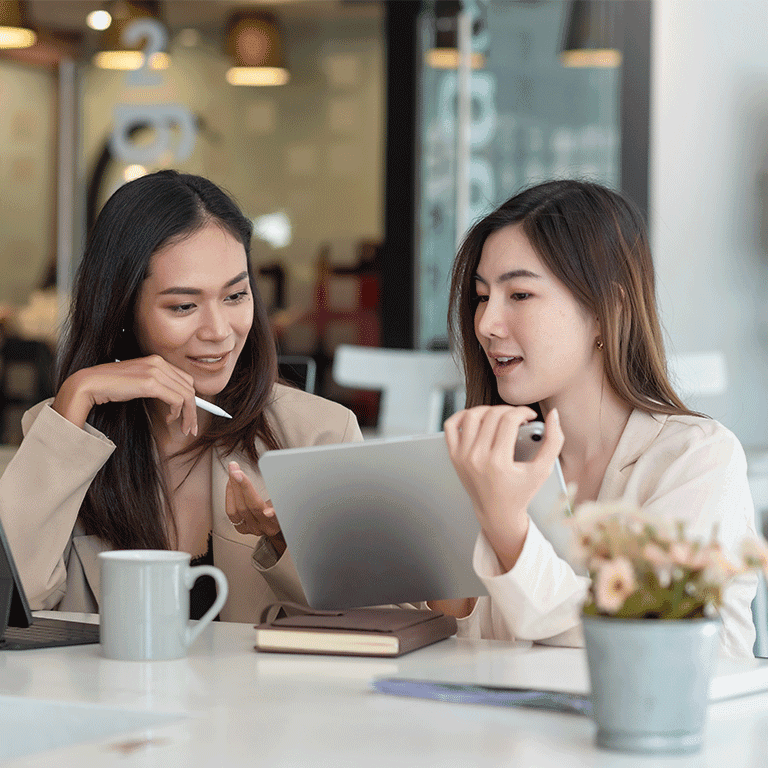 two women looking at a tablet